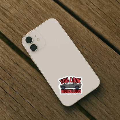 Phone case with 'You Look Ridiculous' design on a wooden surface
