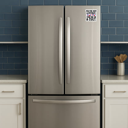 'You're Not a Patriot  You're in a Cult' magnet or vinyl decal displayed on a stainless steel refrigerator. A bold, high-quality political sticker perfect for cars, laptops, fridges, or toolboxes. Great for activists, protestors, or anyone fed up with fascism.